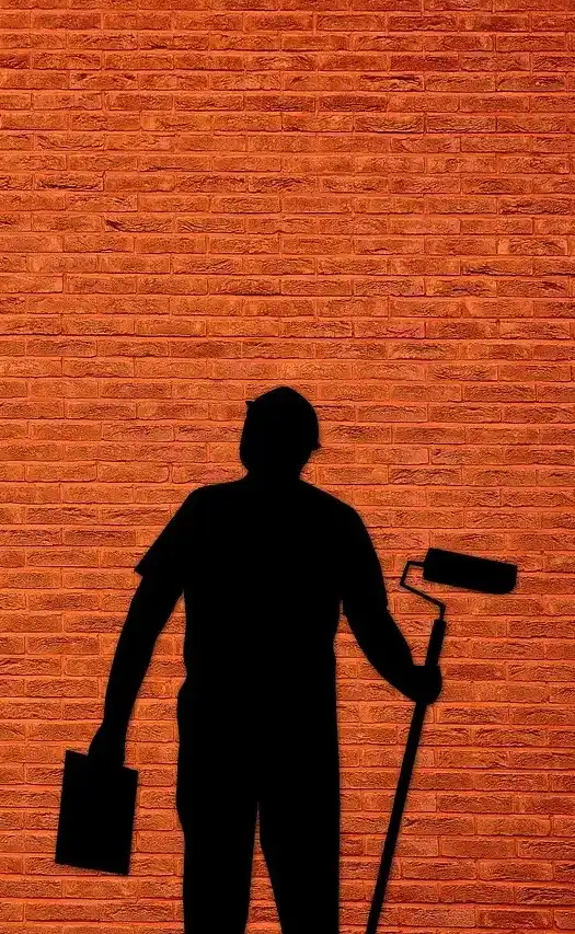 Hombre sonriendo con ropa de trabajo en un entorno laboral